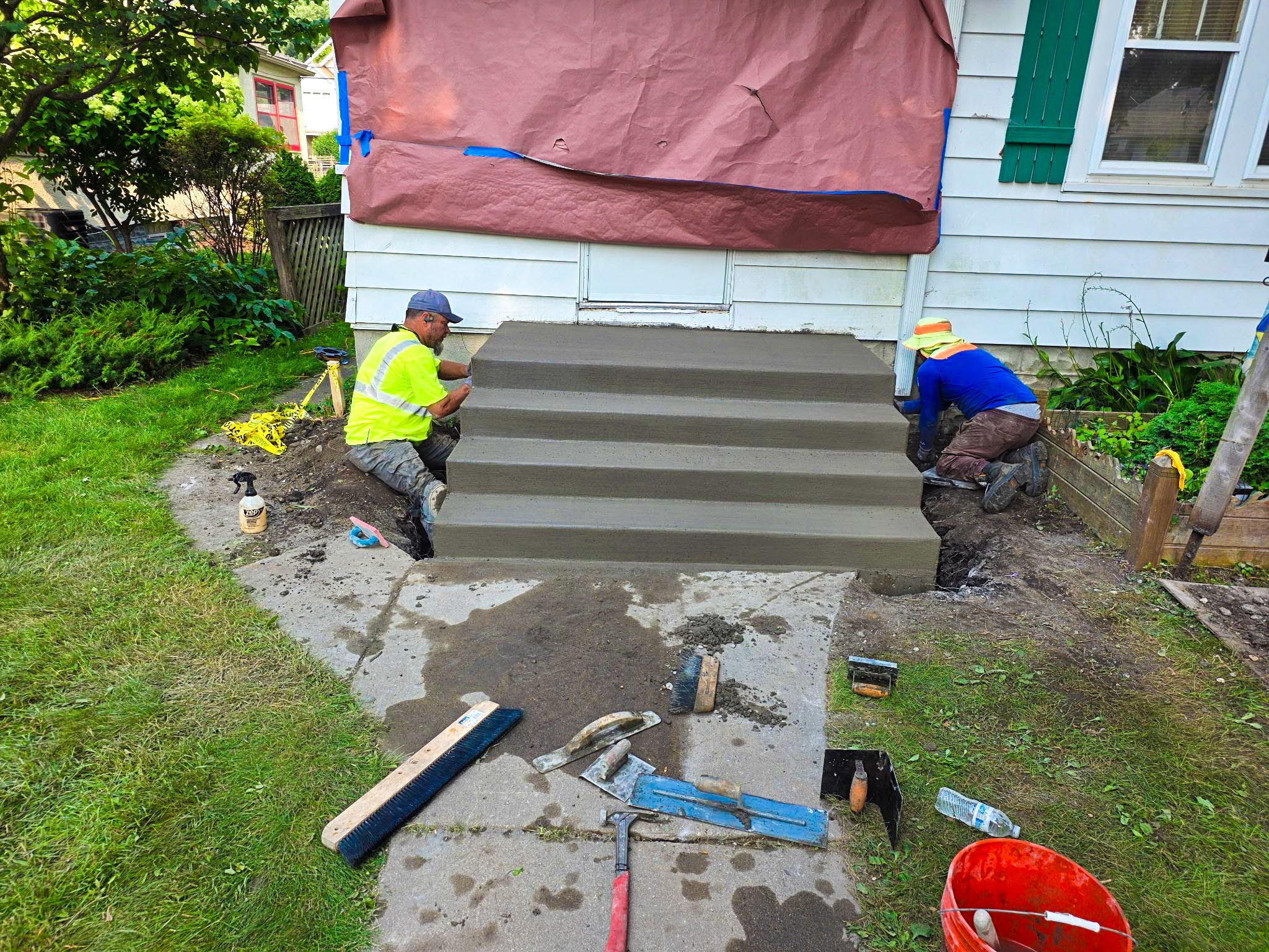 Crew finishing newly formed residential concrete steps
