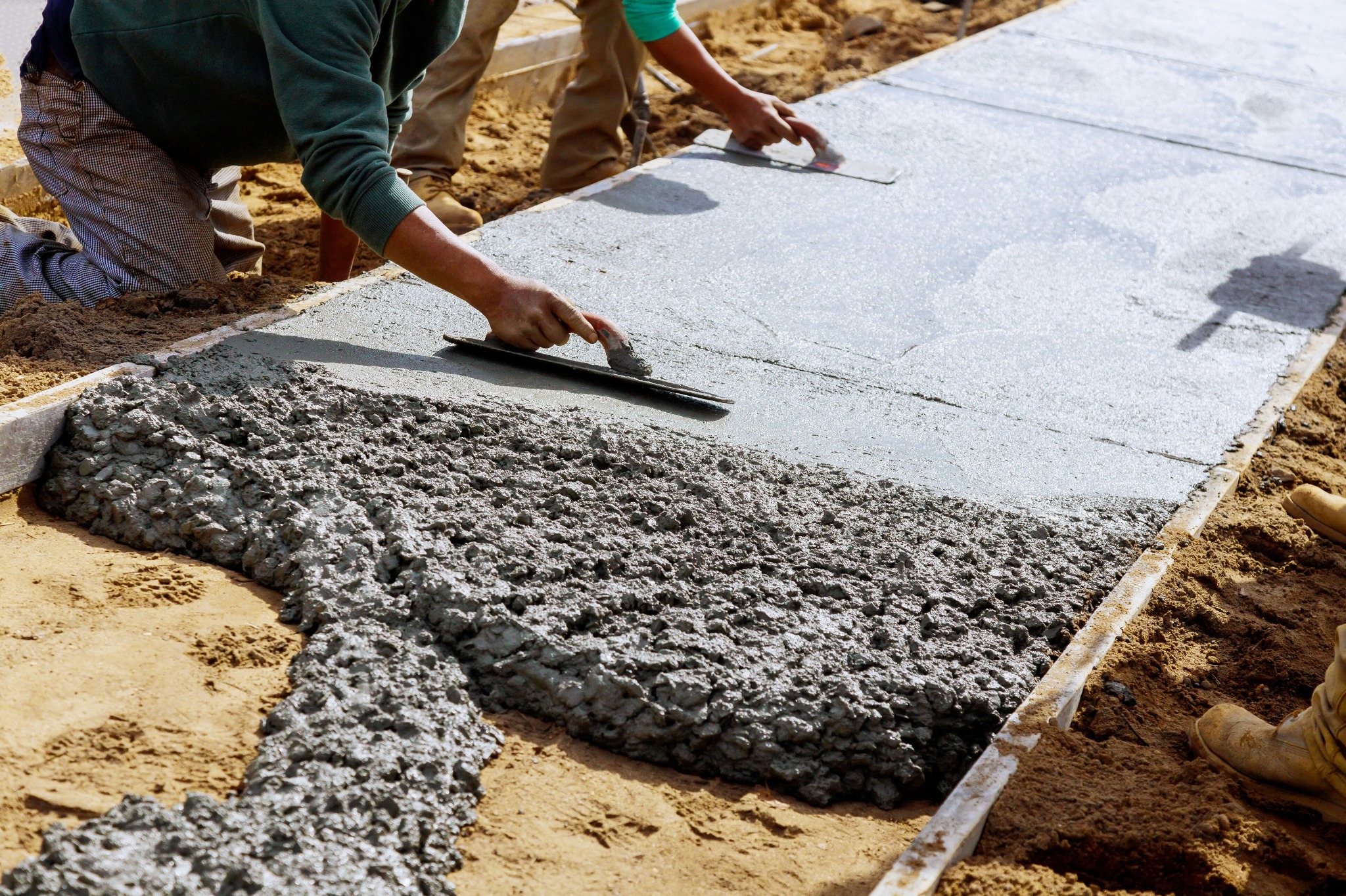 Concrete crew pouring and finishing a sidewalk